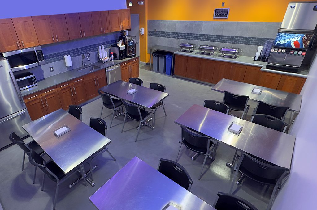 ThunderShot Studios break room and kitchen area with seating, coffee station, and catering setup in Washington DC video production facility