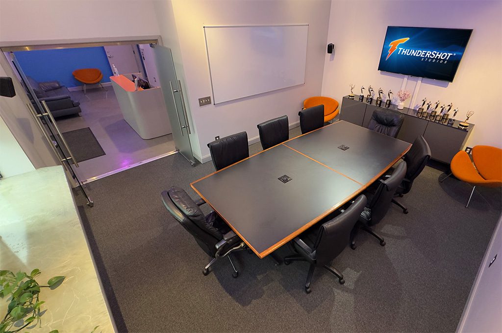 ThunderShot Studios conference room with large meeting table, client seating, and production awards display in Washington DC