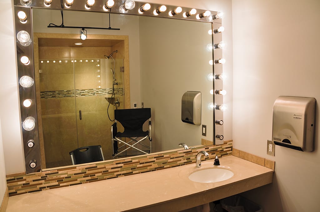 ThunderShot Studios makeup and dressing room with lighted vanity mirror, sink, and private shower for talent prep in Washington DC
